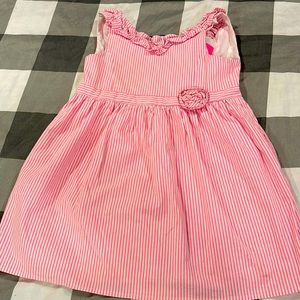 Pink seersucker with ruffle and rosette detail Lily dress